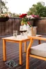 A table setting on a balcony with wine and flowers. Náhled obrázku produktu