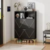 A black shoe cabinet with gold accents and metal legs, placed in a hallway next to a door and a bench. Podgląd zdjęcia produktu