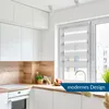 A modern kitchen with white cabinets, wooden backsplash, and a window with a roller blind. Produktbild-Vorschau