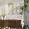 A modern living room with a wooden sideboard, a mirror, and plants. Produktbild-Vorschau