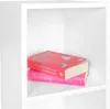 Two books are stacked on a white shelf. Produktbild-Vorschau