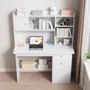 A white computer desk with shelves and drawers, featuring a laptop, books, and decorative items. Podgląd zdjęcia produktu