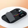 A black multi-device wireless charging station with a digital clock and LED accent lighting. Produktbild-Vorschau