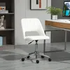 A white office chair is shown in a room with a bookshelf and a desk. Náhled obrázku produktu