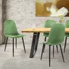 A dining room scene with a wooden table and green velvet chairs. Náhled obrázku produktu