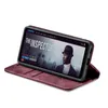 A smartphone in a burgundy flip case, displaying a movie poster on its screen. Produktbild-Vorschau