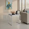 A modern living room with a side table, sofa, and abstract art. Voir les images du produit