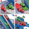 A collage of four images showing a Super Mario Kart Racing Deluxe toy playset with Mario and Luigi characters in their karts on different parts of the track. Produktbild-Vorschau