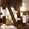 A close-up view of a brown cat tree with sisal-wrapped posts and platforms. Náhľad obrázku produktu