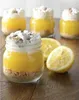 Desserts in jars with lemons on a wooden table. Produktbild-Vorschau