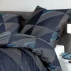 A close-up view of a bed with pillows and bedding. Produktbild-Vorschau
