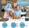 A mother and daughter are decorating cupcakes in a kitchen. Produktbild-Vorschau
