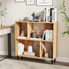 A wooden bookshelf with various decorative items and books on it, placed in a room setting. Podgląd zdjęcia produktu