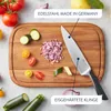 A kitchen scene with a knife, cutting board, and various vegetables being prepared. Produktbild-Vorschau