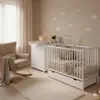 A nursery room with a crib, changing table, and rocking chair. Produktbild-Vorschau