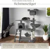 A cat tree with two cats, one jumping and one resting, in a room with a window and a plant. Produktbild-Vorschau