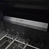Close-up view of a stainless steel heat shield inside a grill. Produktbild-Vorschau