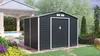 A dark gray garden shed is shown in a backyard setting with landscaping and a patio area. Náhled obrázku produktu