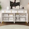 A white sideboard with gold handles and legs, featuring four doors and four drawers, is shown in a room setting. Produktbild-Vorschau