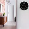 A hallway with a wooden cabinet, a plant, and a wall clock. Anteprima dell’immagine prodotto
