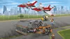 A LEGO City airport scene with two jets in the air, a hangar, a small vehicle, and several minifigures. Produktbild-Vorschau
