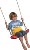 A young boy is happily swinging on a red swing. Anteprima dell’immagine prodotto