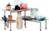 A stainless steel kitchen shelf organizer with various items on it. Anteprima dell’immagine prodotto