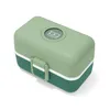 A green and dark green Monbento lunchbox is shown from a slightly elevated angle against a white background. Produktbild-Vorschau