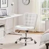 A white office chair is placed next to a white desk in a room with a bed and a window. Produktbild-Vorschau