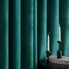 Two white spiral candles in black candle holders are placed on a table in front of green velvet curtains. Produktbild-Vorschau