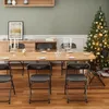 A dining table set with chairs and Christmas decorations, including a Christmas tree. Podgląd zdjęcia produktu