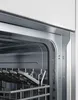 Close-up view of the interior of a dishwasher, showing racks and some dishes. Produktbild-Vorschau