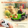 A child is riding a green toy tractor in a farm-like setting with hay bales and pumpkins. A remote control is in the foreground. Náhľad obrázku produktu