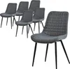 A set of six dining chairs arranged in a group, with one chair prominently in the foreground.
