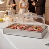 A buffet serving station with two trays of cold cuts and olives, set up on a table at an event with people in the background. Náhľad obrázku produktu