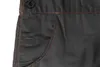 A close-up view of the pocket and button area of a pair of dark gray overalls. Produktbild-Vorschau