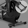 Close-up view of the base and flywheel of a black elliptical trainer, with a magnified inset showing a handle. Podgląd zdjęcia produktu