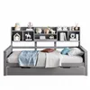 A grey daybed with a bookshelf headboard, made up with bedding and decorative items. Náhled obrázku produktu