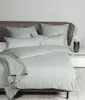 A neatly made bed with striped bedding and a throw blanket. Voir les images du produit