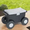 A garden cart with wheels is shown outdoors on a patio with grass and a bush in the background. Produktbild-Vorschau
