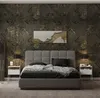 A bedroom scene featuring a bed with nightstands and a decorative wallpaper. Náhled obrázku produktu