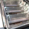 Close-up view of the inside of a grill, showing the burners and heat shields. Anteprima dell’immagine prodotto