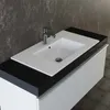 A close-up view of a white ceramic sink with a chrome faucet, installed on a black countertop above a white cabinet. Produktbild-Vorschau