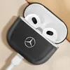 A close-up shot of a black leather AirPods case with the Mercedes-Benz logo, showing the AirPods inside and a charging cable connected. Náhled obrázku produktu