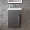 A close-up view of a modern bathroom vanity with a dark gray cabinet, a white countertop, and a silver faucet against a gray marble-patterned wall. Produktbild-Vorschau