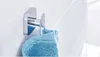 A chrome towel hook mounted on a tiled wall, with a blue towel hanging from it. Anteprima dell’immagine prodotto