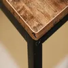 A close-up view of the corner of a wooden desk with a black metal frame. Podgląd zdjęcia produktu