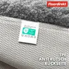 Close-up view of the underside of a rug, showing the backing and a label. Anteprima dell’immagine prodotto