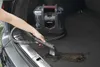 A person is using a portable carpet cleaner in the trunk of a car to clean up dirt. Produktbild-Vorschau