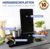 A kitchen counter with a glass stovetop cover, a pot, and vegetables. Produktbild-Vorschau